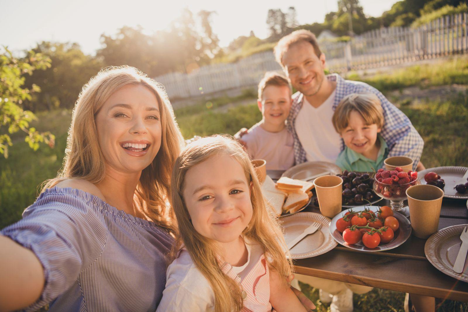 A happy family enjoying a meal together outdoors
