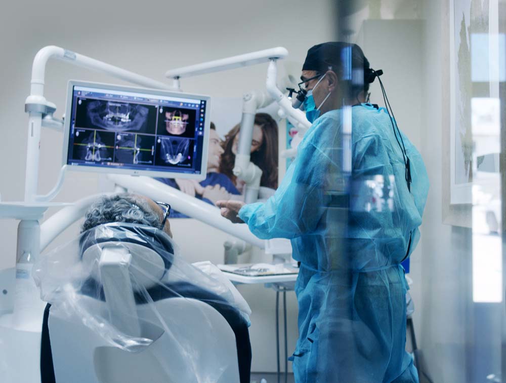 Surgeon performing implant treatment with CBCT imaging